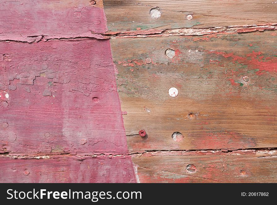 Cloesup of a shipwrecked wooden boat with faded red paint. Cloesup of a shipwrecked wooden boat with faded red paint.