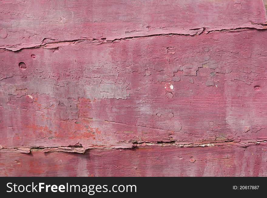 Cloesup of a shipwrecked wooden boat with faded red paint. Cloesup of a shipwrecked wooden boat with faded red paint.