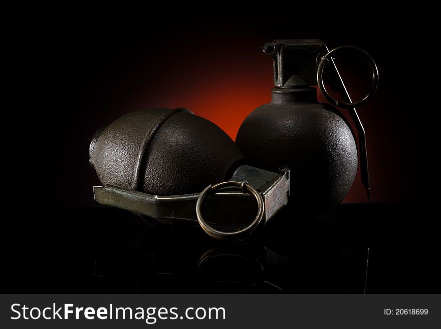 Two hand grenades on dark background
