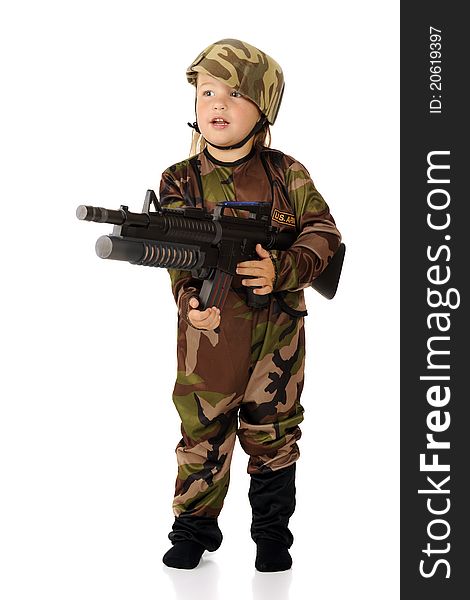 A pretty preschooler in soldier garb standing at the ready with a toy machine gun. Isolated. A pretty preschooler in soldier garb standing at the ready with a toy machine gun. Isolated.