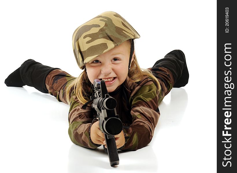 A cute preschool girl in army camouflage laying on the floor aiming her maching gun. Isolated on white. A cute preschool girl in army camouflage laying on the floor aiming her maching gun. Isolated on white.