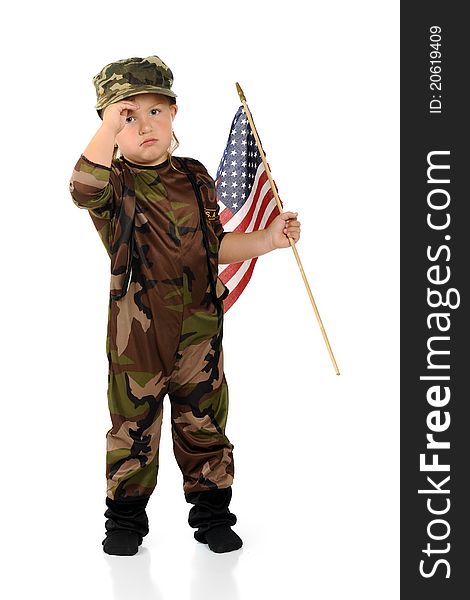 A pretty preschool soldier in army camouflage saluting as she carries an American flag. Isolated. A pretty preschool soldier in army camouflage saluting as she carries an American flag. Isolated.