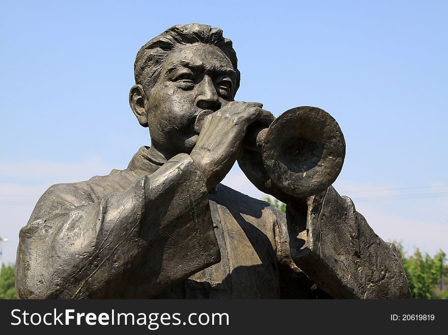Sculpture of the man blowing zurna, closeup of pictures