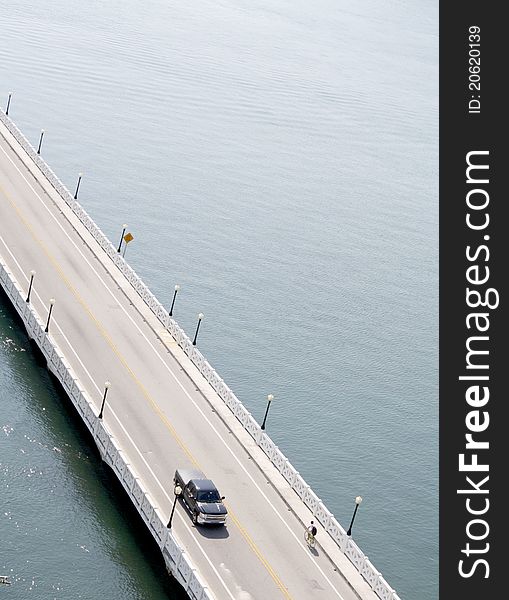 Bike and Truck on road bridge over water. Bike and Truck on road bridge over water