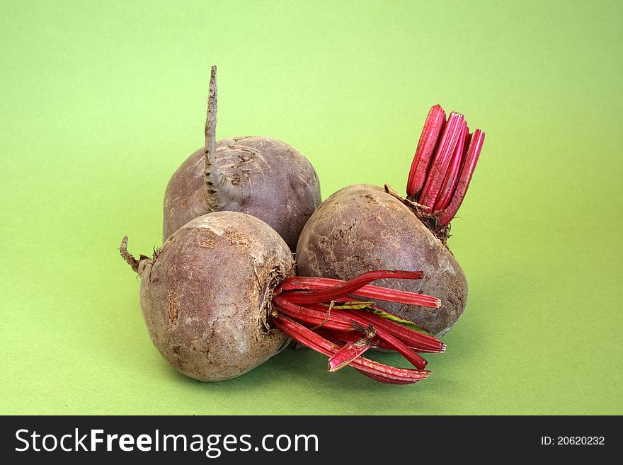 Raw beetroot over green background
