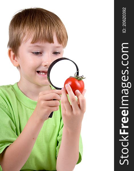 Boy Examines A Tomato With A Magnifying Glass