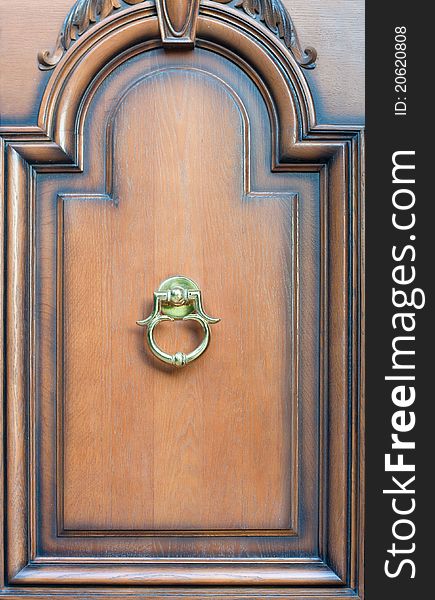 Modern door knock on brown background