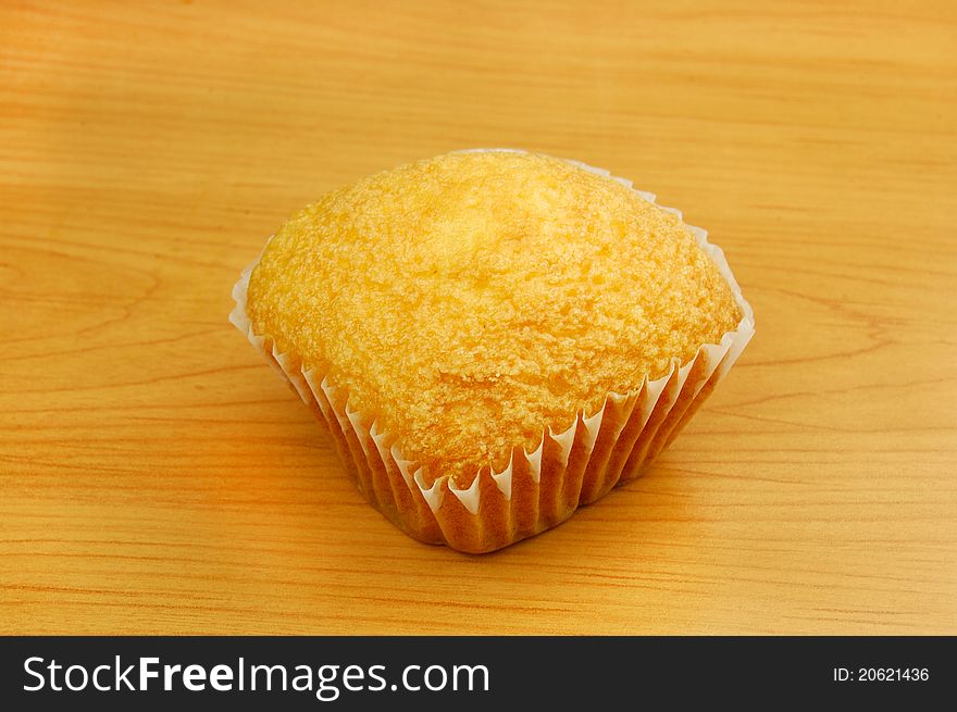 Cupcakes on yellow background, one