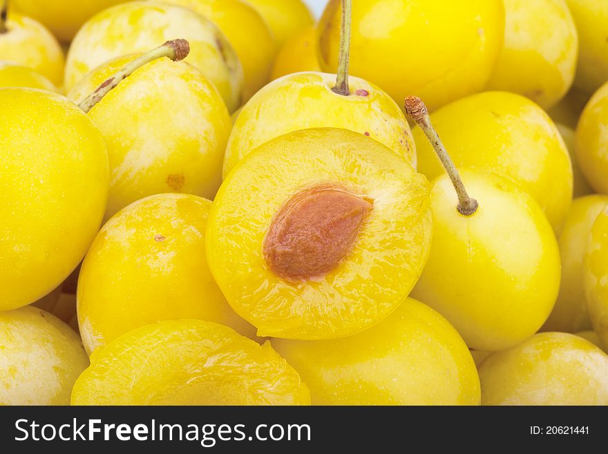 Studio-shot of small yellow plums also known as mellow mirabelles.