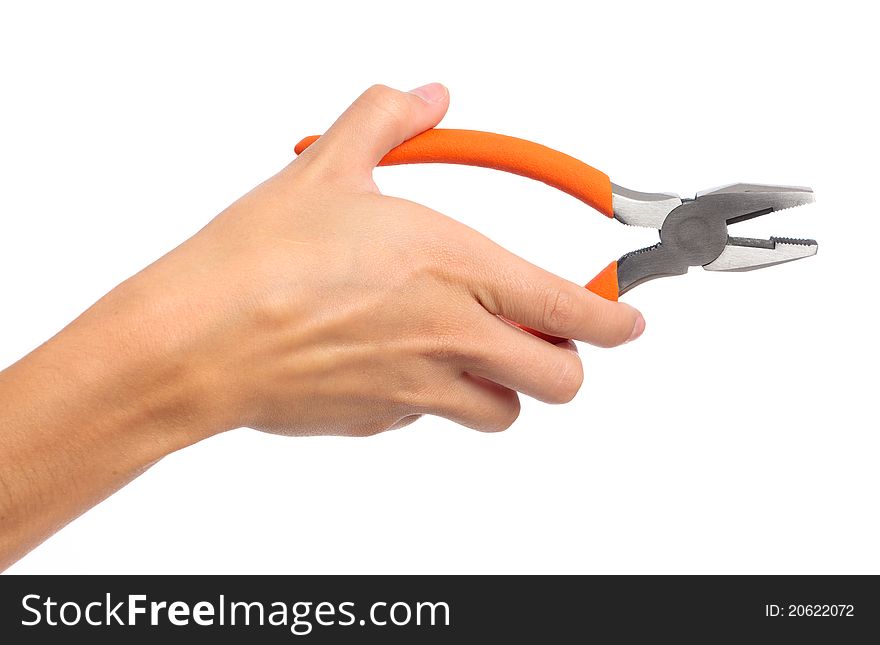 A female hand holding a pair of pliers on an isolated white background. A female hand holding a pair of pliers on an isolated white background