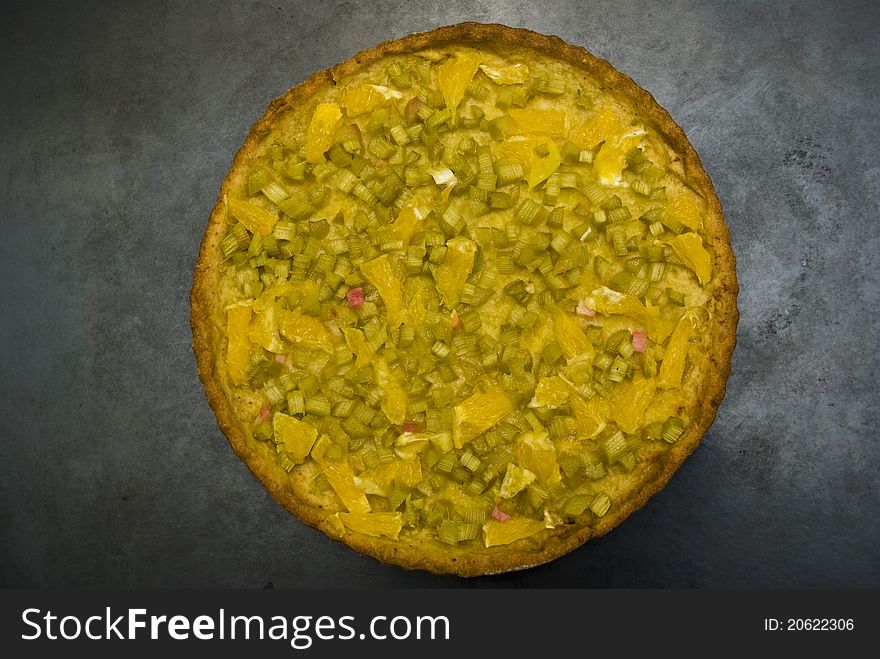 Delicious pie with fine cut green pieplant on a metal baking sheet. Delicious pie with fine cut green pieplant on a metal baking sheet