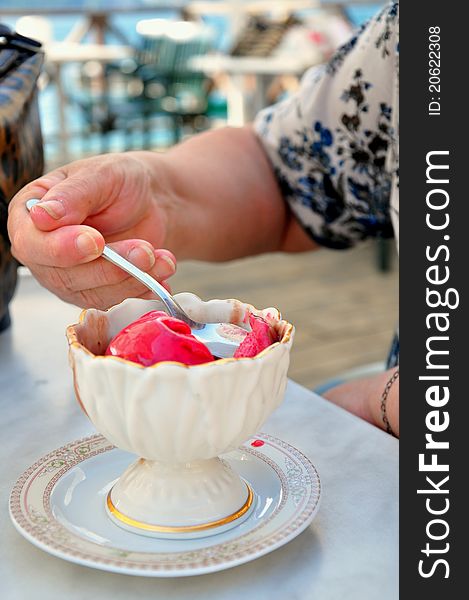 A hand taking a spoon of ice cream