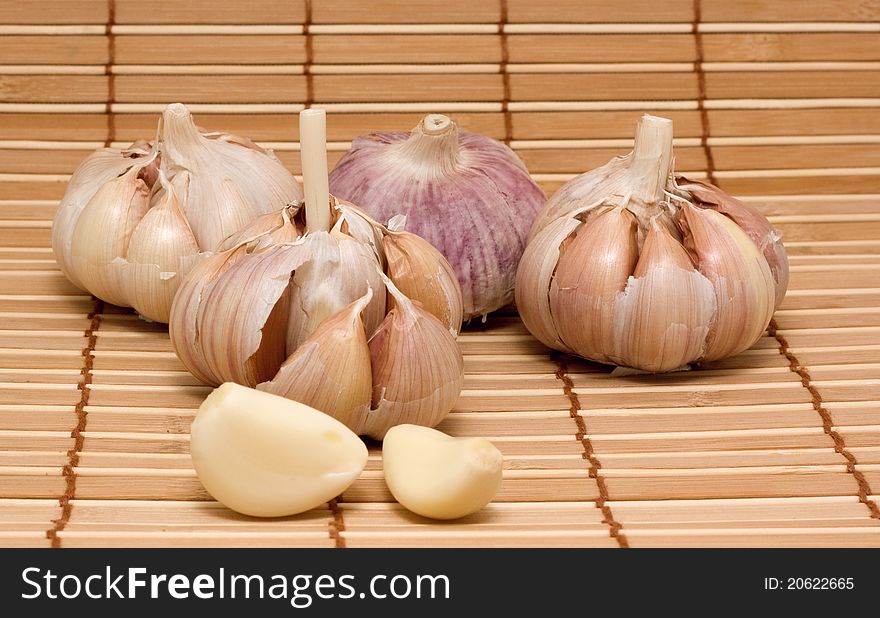 Spice garlic on wood background