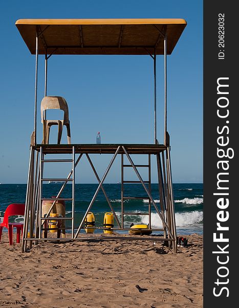 A life guard's outlook platform on North Beach, Durban, South Africa, with no life guard in sight. only his water bottle left on the platform. A sunny, cloudless day. A life guard's outlook platform on North Beach, Durban, South Africa, with no life guard in sight. only his water bottle left on the platform. A sunny, cloudless day.