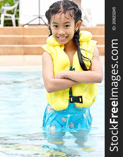 Cute Young Girl Standing In A Pool