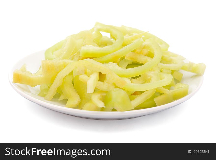 Cut peppers in a plate on a white background