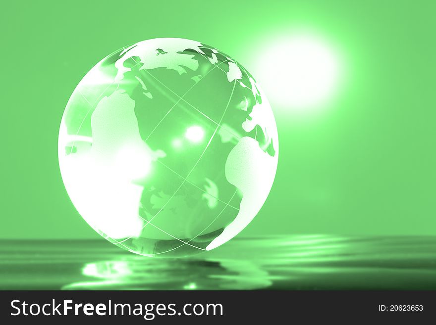 Glass globe with bright highlights on a green background. Glass globe with bright highlights on a green background