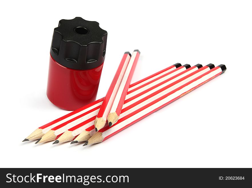 Red pencil sharper with pencils on a white background