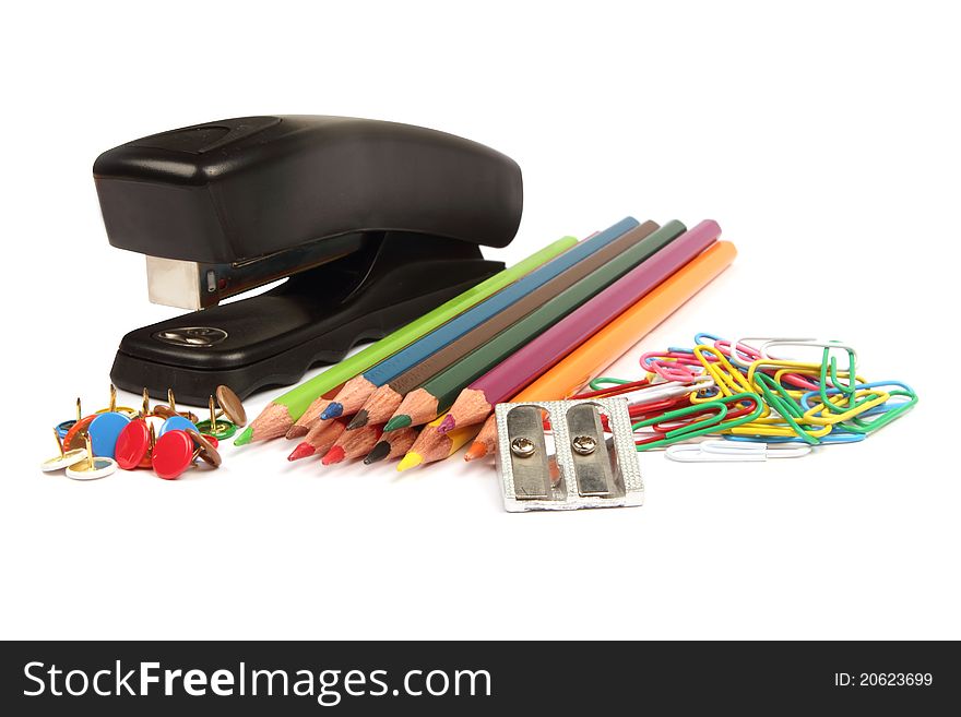 Stationery including pencils, stapler, sharpener and paperclips isolated on white. Stationery including pencils, stapler, sharpener and paperclips isolated on white