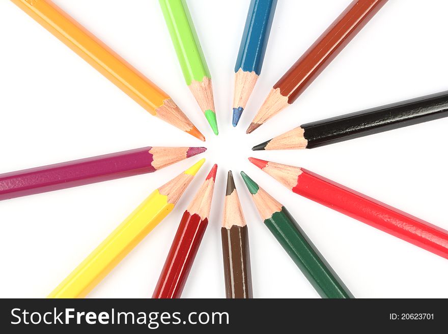 Colorful pencils arranged in a pattern forming a circle. Colorful pencils arranged in a pattern forming a circle