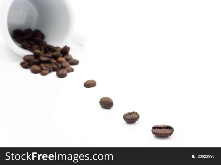 Cup with coffe beans on white background