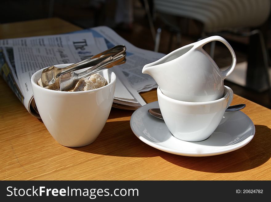 Businessman breakfast with a newspaper and a cup of coffee with cream. Businessman breakfast with a newspaper and a cup of coffee with cream