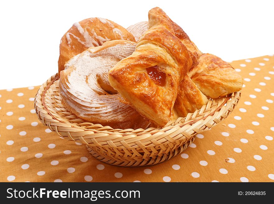 Many rolls in a basket on the tablecloth. Many rolls in a basket on the tablecloth