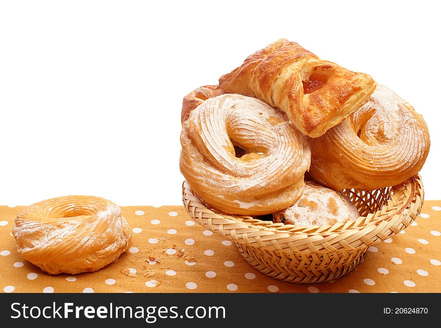 Many rolls in a basket on the tablecloth. Many rolls in a basket on the tablecloth