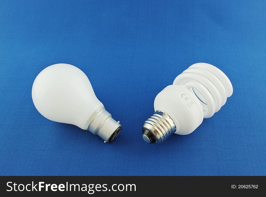 Comparison of old & new light bulbs on blue background