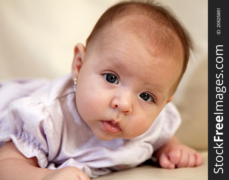 An eye level closeup of 3 month old girl. An eye level closeup of 3 month old girl