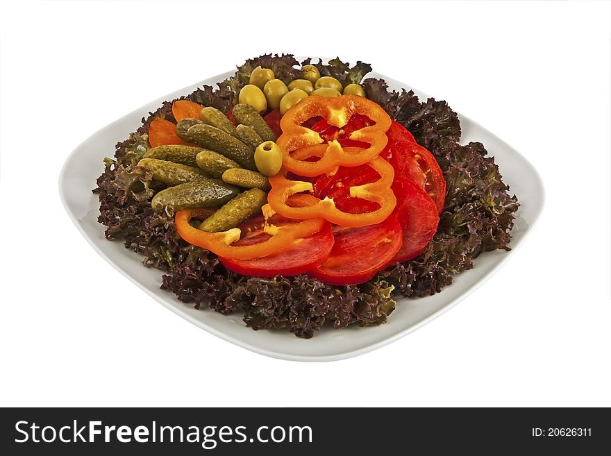 A plate of salad with fresh lettuce, tomato, olive, sweet pepper and pickle. A plate of salad with fresh lettuce, tomato, olive, sweet pepper and pickle