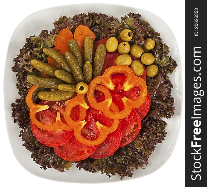 A plate of salad with fresh lettuce, tomato, olive, sweet pepper and pickle. A plate of salad with fresh lettuce, tomato, olive, sweet pepper and pickle