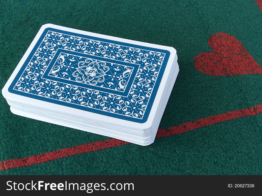 Deck of cards face down on a card table