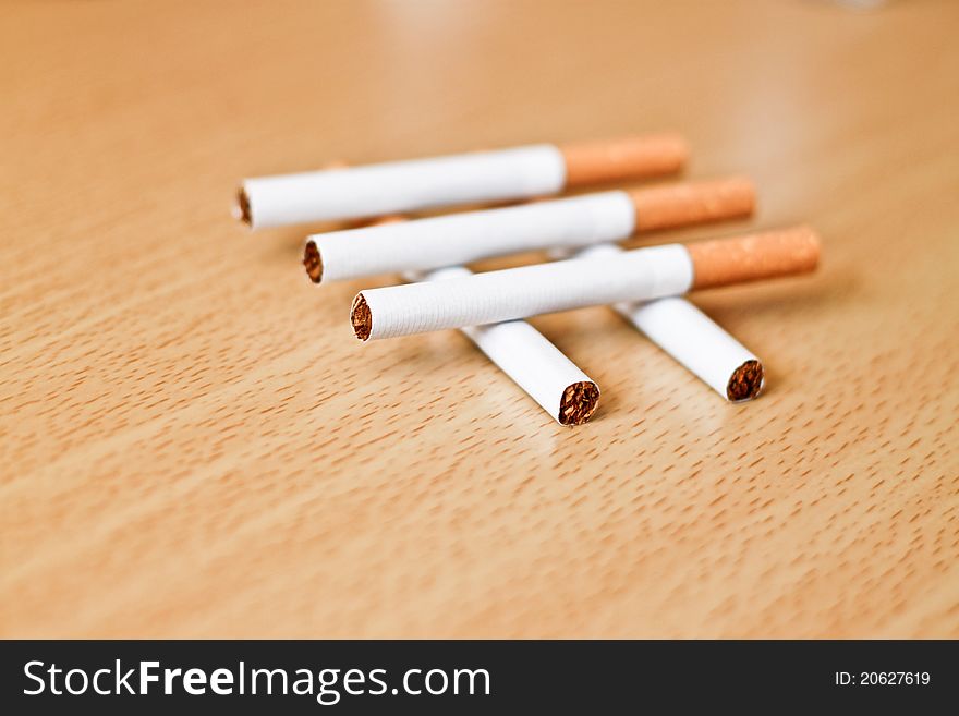 Five cigarettes on a table