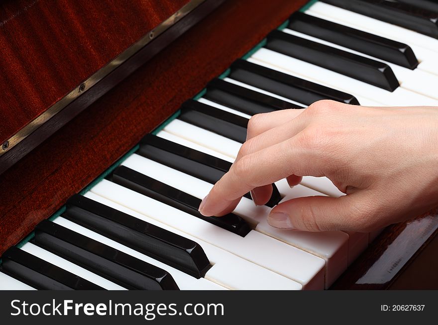 Playing the piano: closeup of a hand