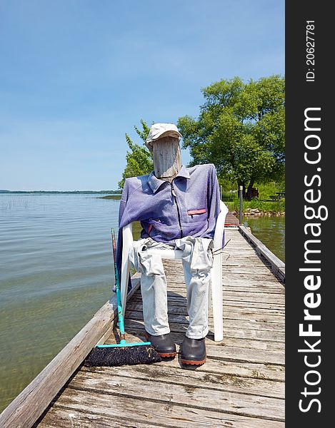 Funny close up image of a human decoy on a dock in the summer placed there to keep seagulls away. Funny close up image of a human decoy on a dock in the summer placed there to keep seagulls away.