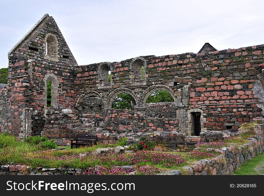 St Augustine Nunnery. Chapel ruins, Iona, Argyll and Bute, Scotland, U.K The nunnery was founded after the establishment of the Benedictine monastery, which was likely founded by Raghnall mac Somhairle in 1203. Raghnall&#x27;s sister, Bethóc, became the first prioress. This was one of the two Augustinian nunneries in Scotland, St. Leonards Nunnery located at Perth being the other. In the Abbey museum of the nearby Iona Abbey, the top half of a headstone of Anna MacLean, a prioress of the monastery of nuns who died in 1543, is on display. Restoration work on the nunnery occurred in 1923 and 1993. The construction of the Iona Nunnery follows the typical Irish style. The Church consists of a building with three bays with a passage to the north side and a small chapel on the east side of the passage. The current monastery garden measures 14 metres square, but it was originally smaller. The east wing had three rooms on the ground level, above was the dormitory. The south wing contained the refectory. In the sixteenth century, a floor was added. The west wing is below the modern road and was most likely the guest&#x27;s wing. St Augustine Nunnery. Chapel ruins, Iona, Argyll and Bute, Scotland, U.K The nunnery was founded after the establishment of the Benedictine monastery, which was likely founded by Raghnall mac Somhairle in 1203. Raghnall&#x27;s sister, Bethóc, became the first prioress. This was one of the two Augustinian nunneries in Scotland, St. Leonards Nunnery located at Perth being the other. In the Abbey museum of the nearby Iona Abbey, the top half of a headstone of Anna MacLean, a prioress of the monastery of nuns who died in 1543, is on display. Restoration work on the nunnery occurred in 1923 and 1993. The construction of the Iona Nunnery follows the typical Irish style. The Church consists of a building with three bays with a passage to the north side and a small chapel on the east side of the passage. The current monastery garden measures 14 metres square, but it was originally smaller. The east wing had three rooms on the ground level, above was the dormitory. The south wing contained the refectory. In the sixteenth century, a floor was added. The west wing is below the modern road and was most likely the guest&#x27;s wing.