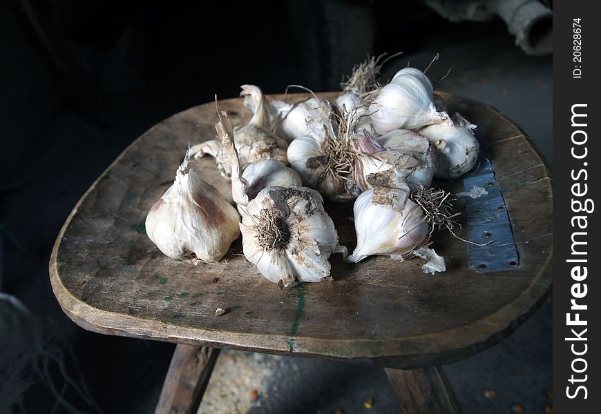 Pieces of garlic on a rural chair. Pieces of garlic on a rural chair