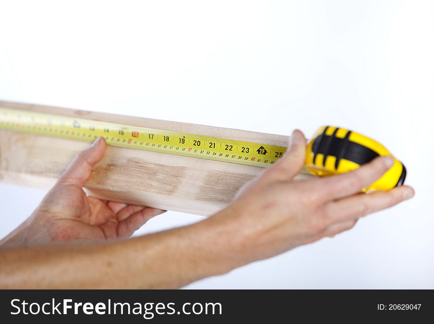 Closeup of measuring tape and wood