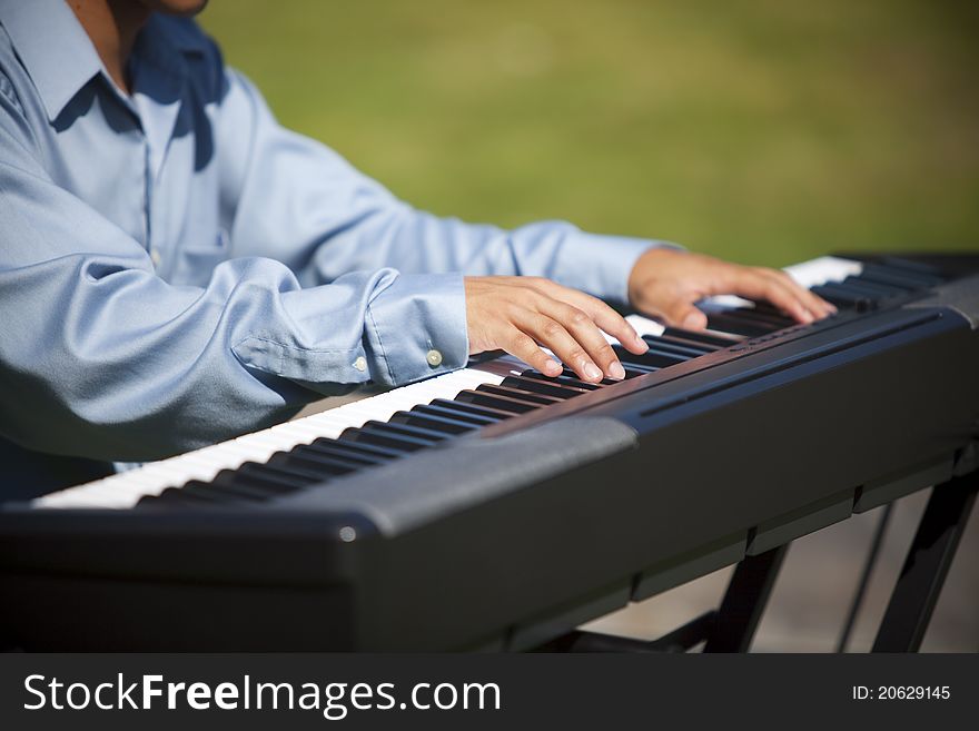 Closeup of a pianist playing a keyboard