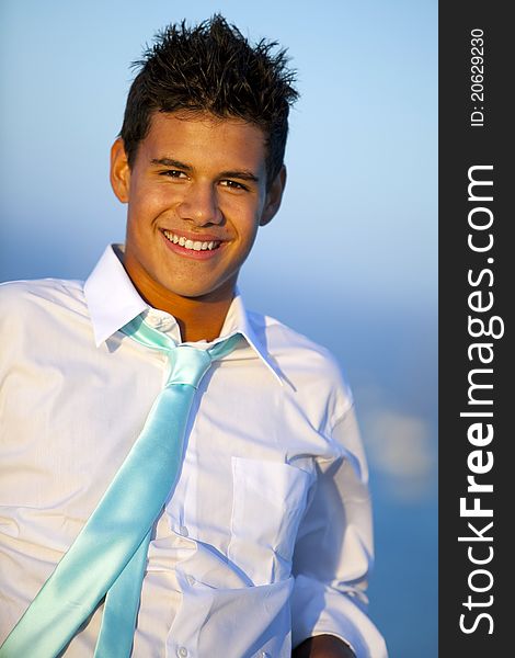 Young man on a pier in a tie at sunset. Young man on a pier in a tie at sunset