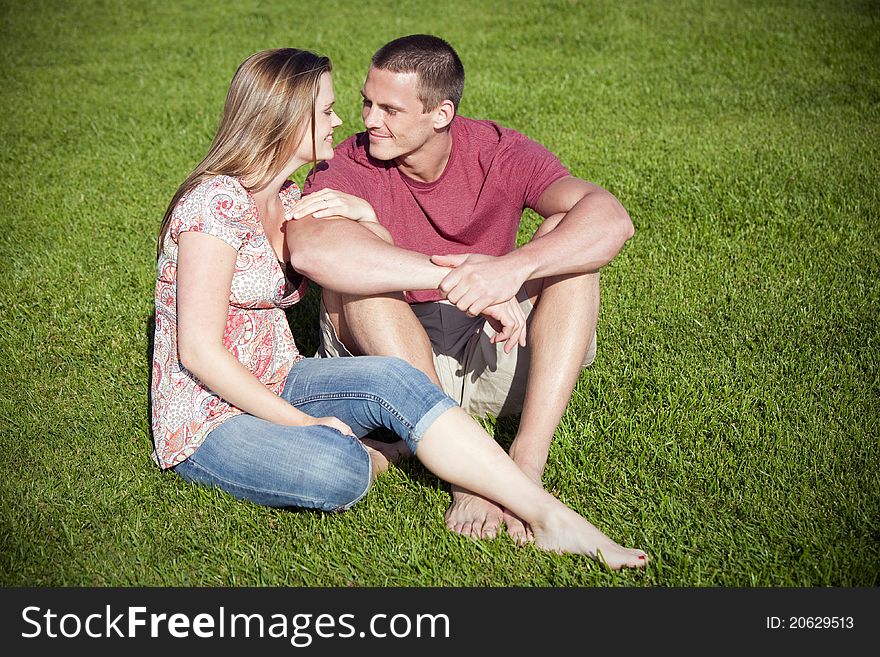 Loving couple sitting in the grass