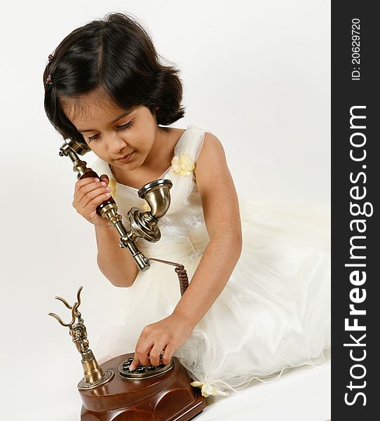 Sweet and cute toddler posing for camera and using phone. Sweet and cute toddler posing for camera and using phone