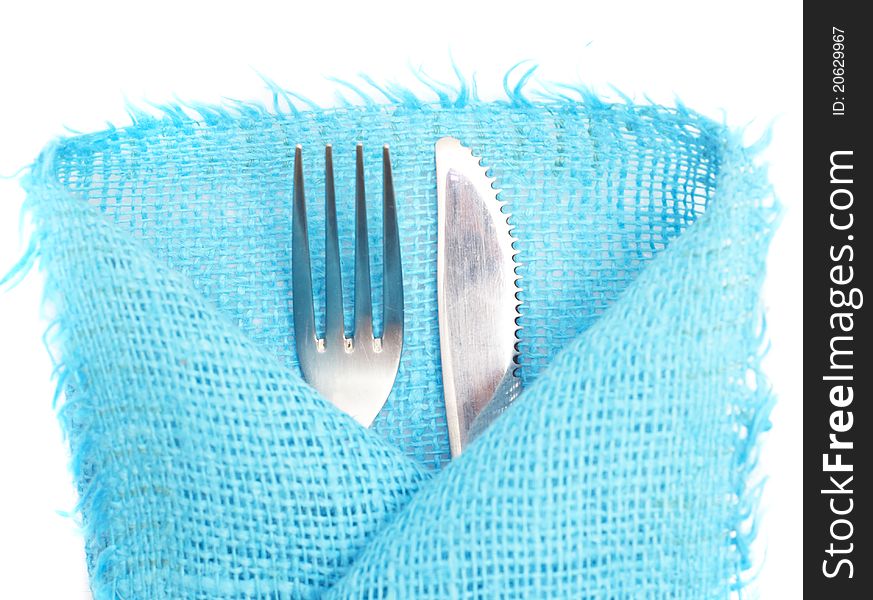 Knife, fork and a napkin on a white background