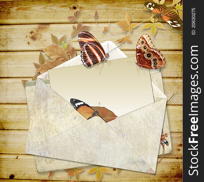 Wooden background with butterflies and envelope with space for text or photo