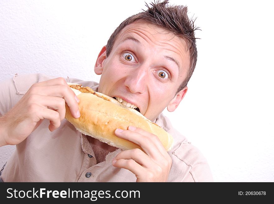 Portrait of a young man eating a sandwich