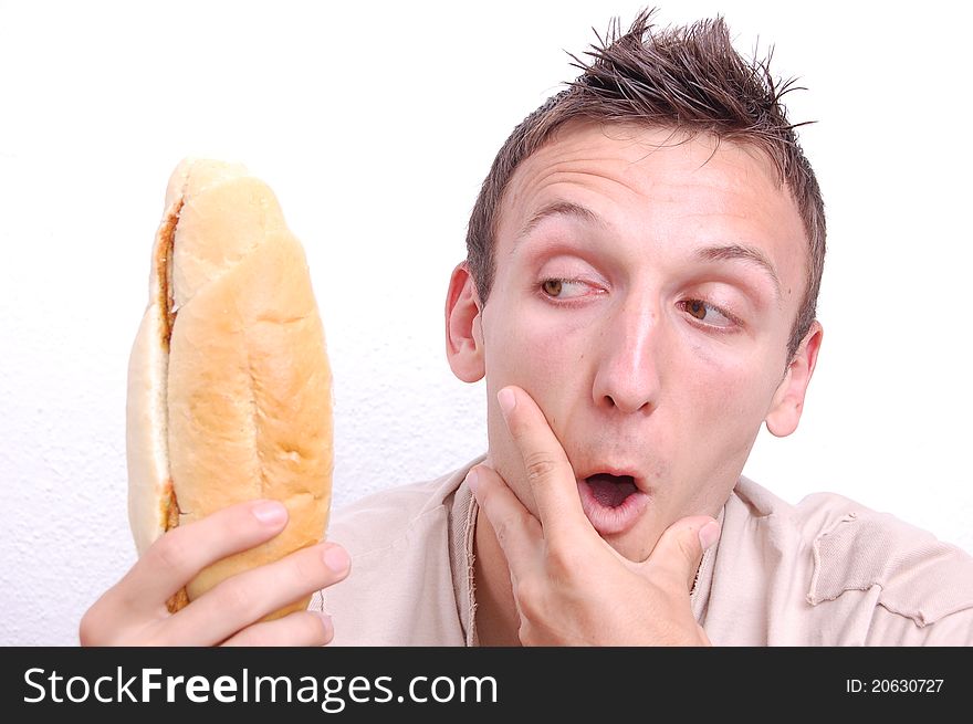 Portrait of a young man looking at his sandwich