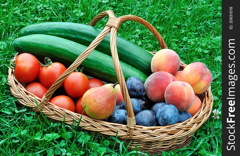 Colorful fresh group of fruits and vegetables in basket on grass. Colorful fresh group of fruits and vegetables in basket on grass