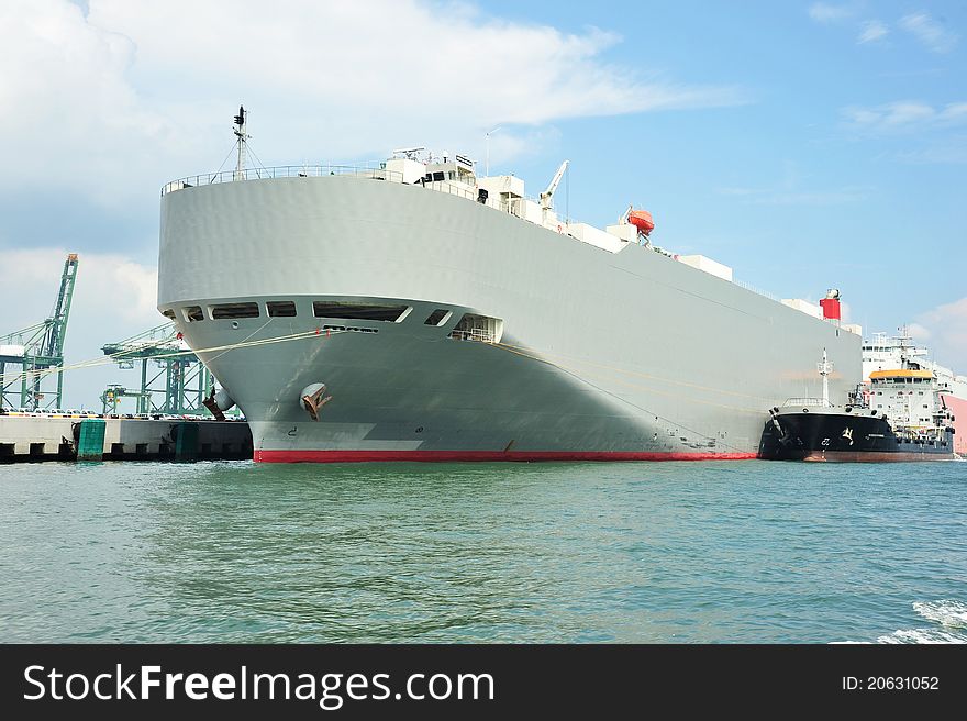 Huge Cargo Ship Berth At A Busy Port. Huge Cargo Ship Berth At A Busy Port