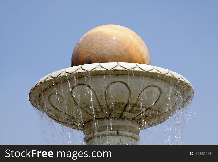 Revolving stone ball in cement platform